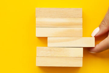 Closeup image of hands showing blank wooden cube blocks