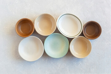 Collection of many empty soft color bowls, top view