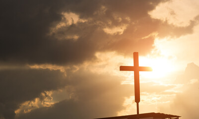 A cross under the sunset sky