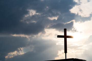 A christian cross under the dark sky