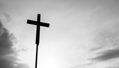 A christian cross under the dark sky