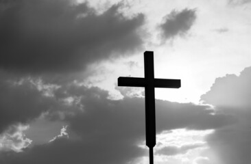 A christian cross under the dark sky
