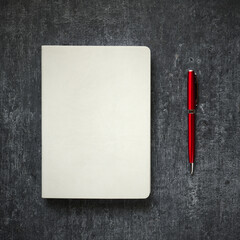 White leather business diary and red metal ballpoint pen close-up on gray background - 496159488