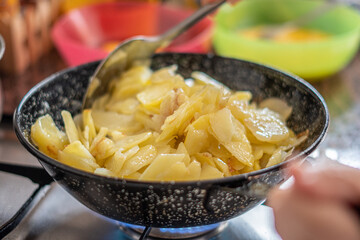 Frying potatoes in a pan.