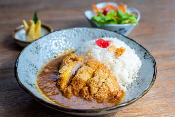 Curry rice with crispy fired pork cutlet a famous and delicious traditional japanese food.