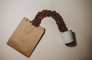 Two disposable craft glasses with package, gift box and coffee beans on craft background ....