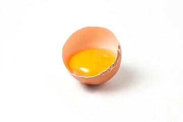 Raw broken egg on a white background. Chicken egg yolk. Healthy diet