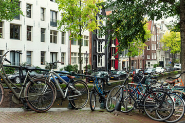 Bicycles on a bridge in Amsterdam on a rainy autumn day.