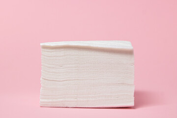 White table napkins on a pink background. Cleaner. paper napkins