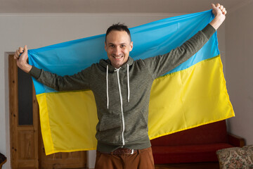 Happy young man with Ukrainian flag.