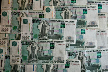 A scattering of one-thousand ruble bills