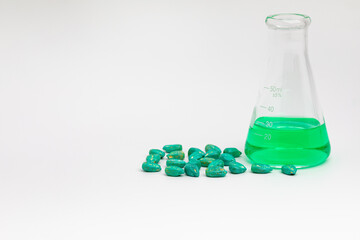 Treated corn seed and laboratory beaker. Corn seed treatment for insect, pest control and disease management concept