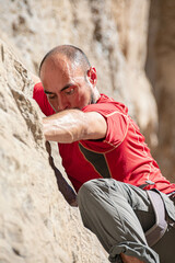 closeup of a man climbing on rock © Claudia Luna