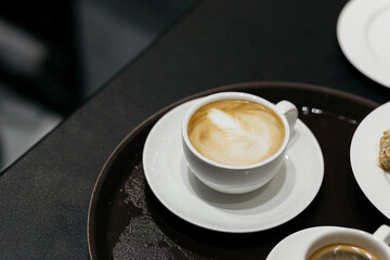 Espresso coffee on a wooden table. Coffee in a small cup. Good morning. Small cups of coffee. Grain.