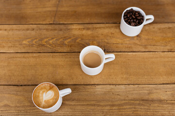 Espresso coffee on a wooden table. Coffee in a small cup. Good morning. Small cups of coffee. Grain.