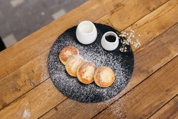 Cheese pancakes, homemade traditional Ukrainian and Russian matches, selective focus. Cheesecakes on a plate.