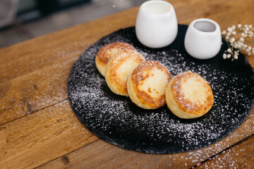 Cheese pancakes, homemade traditional Ukrainian and Russian matches, selective focus. Cheesecakes on a plate.