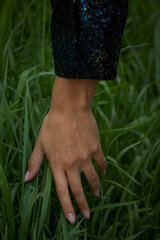 a hand goes through the grass