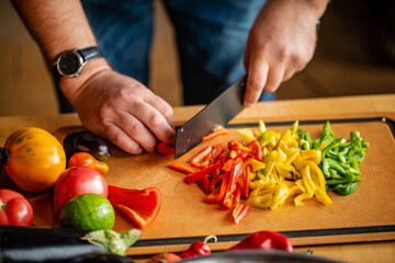 Chef cutting fresh and delicious vegetables for cooking