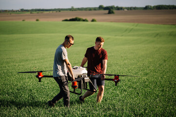 Farmer with drone walking beside grass silage crop in field © Roman