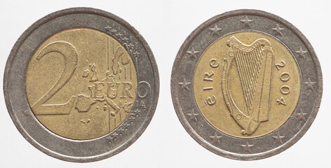 Ireland - circa 2004 : a 2 Euro coin of Ireland with a map of Europe and the Irish harp musical...