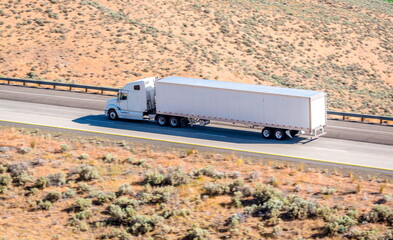Long white semi-truck on the highway