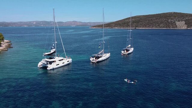 Fly out from anchored sailing yachts