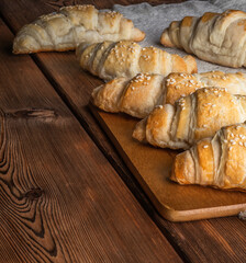 Freshly baked croissants on wooden background. Homemade croissants
