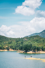 family playing in the coastline of Tai Lam Chung Reservoir, Hong Kong, summer, daytime