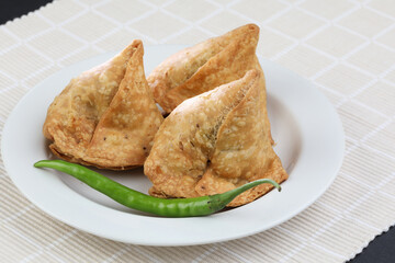 Veg Samosa - is a crispy and spicy Indian triangle shape snack which has crisp outer layer of maida...