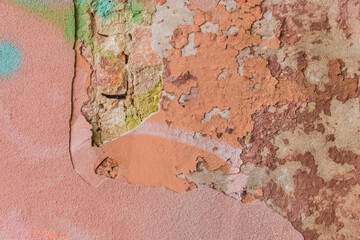 Old colored worn weathered concrete peeling plaster wall texture background