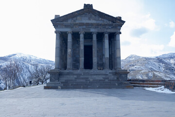 an ancient temple stands among the winter mountain peaks