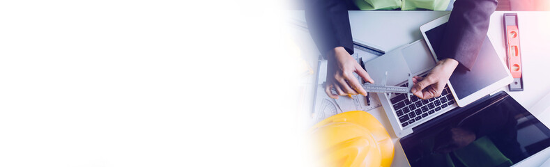 engineer working at a drawings of house in office for discussing. Engineering tools and...