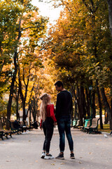 Fototapeta premium Couple in love walking in the park holding hands