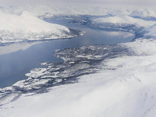 Fototapeta na wymiar Aerial view of white snow covered city Tromso Norway winter, Snowscape wallpaper