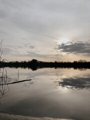 Beautiful sunset over an autumn lake and dry plants