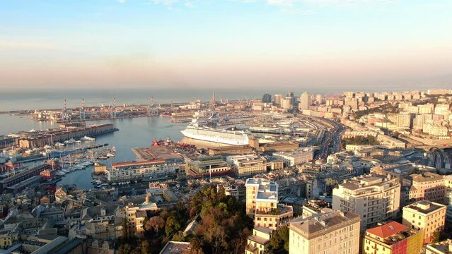aerial view drone of genova historic city center and port italy,panoramic view of italian town of genoa at sunrise flying forward over old downtown 4k
