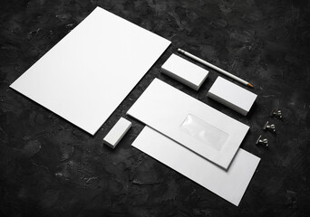 Blank corporate identity template on black plaster background. Photo of blank stationery set. Mockup for design presentations and portfolios.