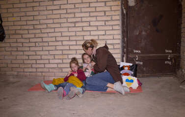 A mother with her young children while they are preparing for an attack by a Russian aggressor in a...