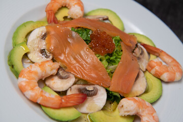 Healthy breakfast with salmon, salad, avocado mushroom, salmon egg, red onion