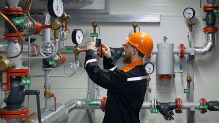 The operator of the booster pumping station conducts a round of equipment, checks pressure gauges...