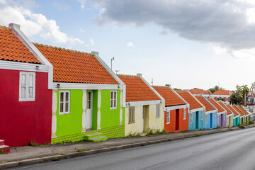 Fototapeta na wymiar Small colorful houses along the road somewhere in Willemstad, Curacao