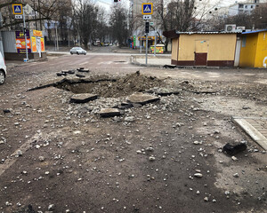 Kharkiv Ukraine 2022 Destruction in the city after the Russian attack. Destroyed infrastructure of the city. A shell crater in the courtyard of the city.