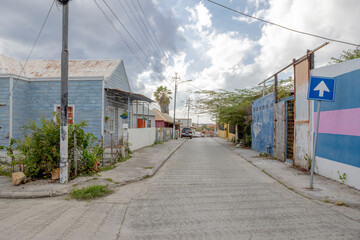 Fototapeta na wymiar House with light blue wooden facade and white framing in the suburbs of Willemstad, Curacao