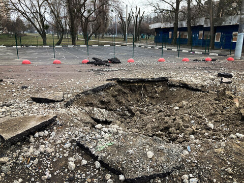 Kharkiv Ukraine 2022 Destruction in the city after the Russian attack. Destroyed infrastructure of the city. A shell crater in the courtyard of the city.