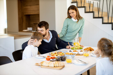 Young mother preparing breakfast for her family in the kitchen