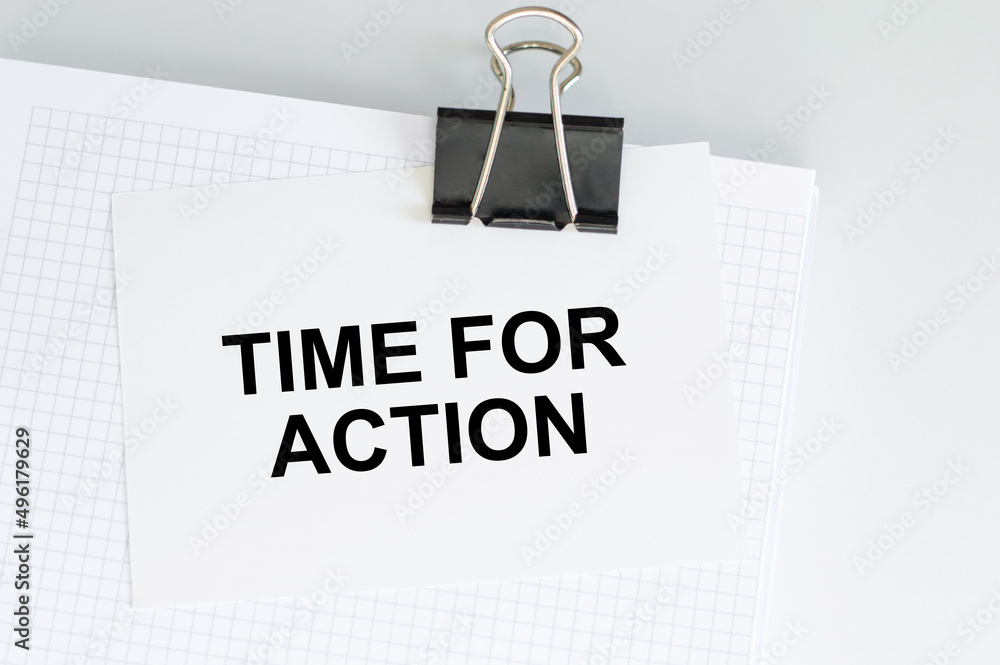 Poster a white card with time for action text on a white notepad on the table, business concept