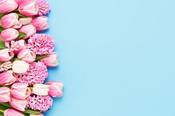 Bunch of pink tulips and hyacinth on blue background. Mothers Day, Valentines Day, birthday concept