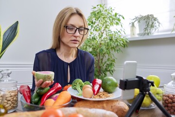 Woman telling and showing healthy food, vegetables fruits nuts eggs cereals
