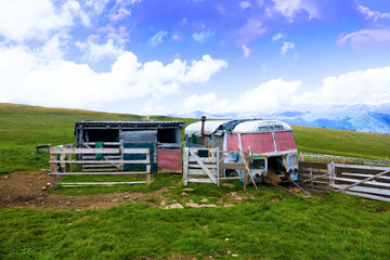 Shepherd's hut in the form of an old bus body in mountain pasture